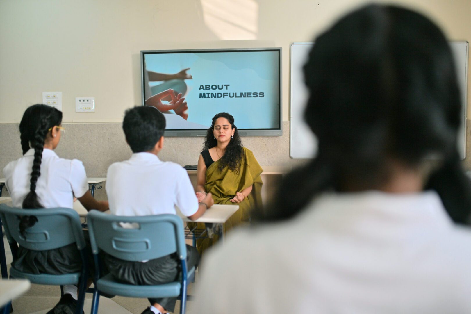 Teacher engaging students with a presentation on about mindfulness.